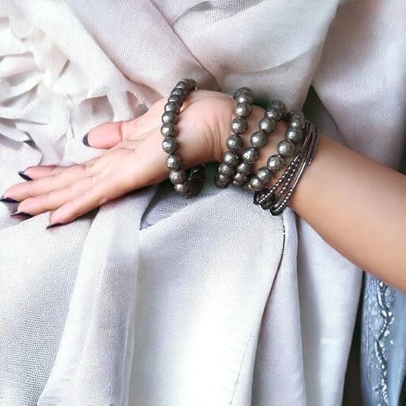 Model wearing the Divinity Healing Crystals Pyrite Money Magnet bracelet for confidence and abundance.