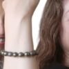 Model wearing the Divinity Healing Crystals Pyrite Money Magnet bracelet for confidence and abundance.