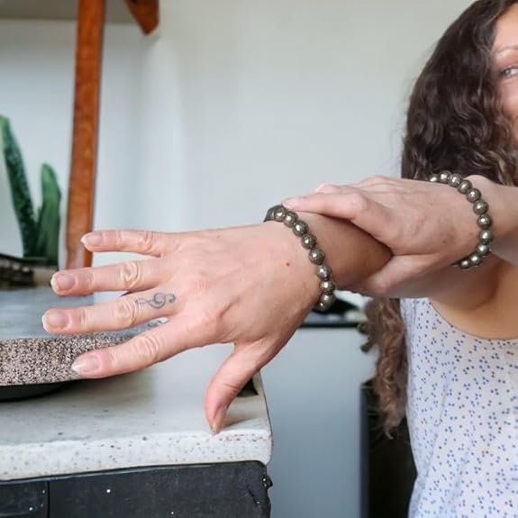 Model wearing the Divinity Healing Crystals Pyrite Money Magnet bracelet for confidence and abundance.